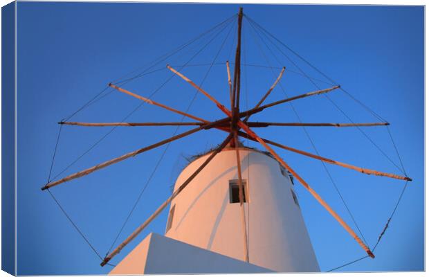 Santorini windmill with the bleu sky Canvas Print by Olga Peddi