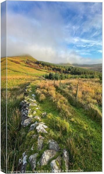 misty sunrise over stone wall and mountains  Canvas Print by Jonny Angle