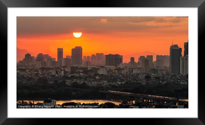 Sunset over Long Bien bridge with a train homing i Framed Mounted Print by Thang Nguyen