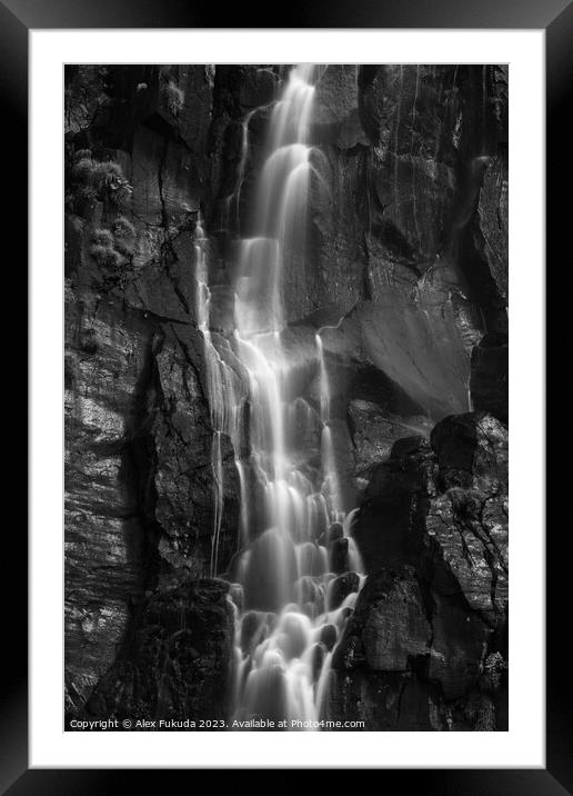 A waterfall cascading down black rock cliff Framed Mounted Print by Alex Fukuda