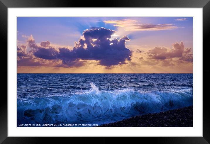 Sunset from Brighton beach with light glistening on the sea spray Framed Mounted Print by Iain Lockhart