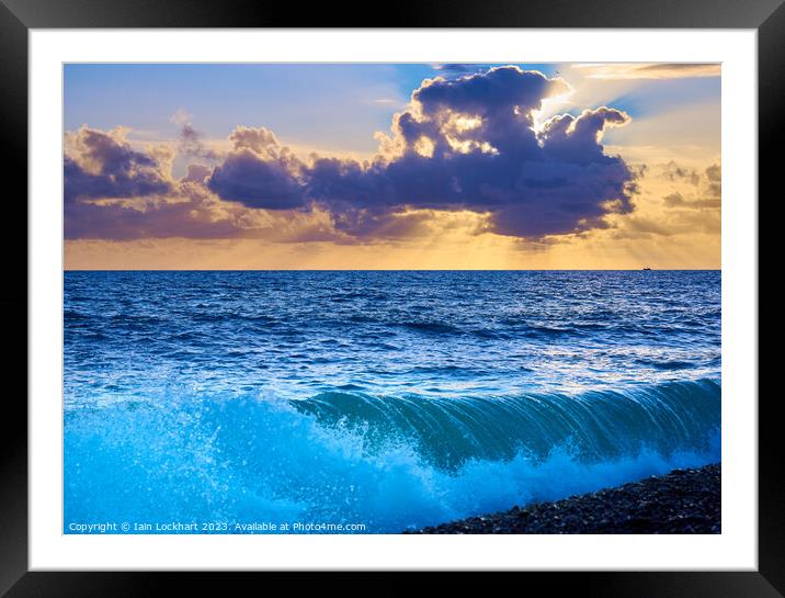 Sunset from Brighton beach with light glistening on rolling waves Framed Mounted Print by Iain Lockhart
