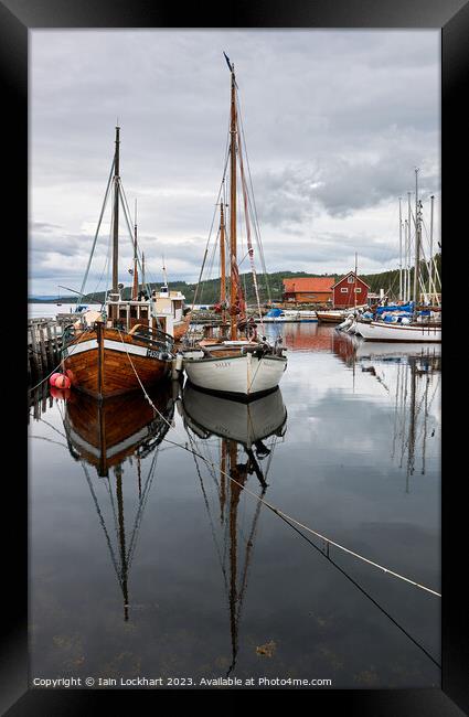 Boat reflection in the fjord Framed Print by Iain Lockhart