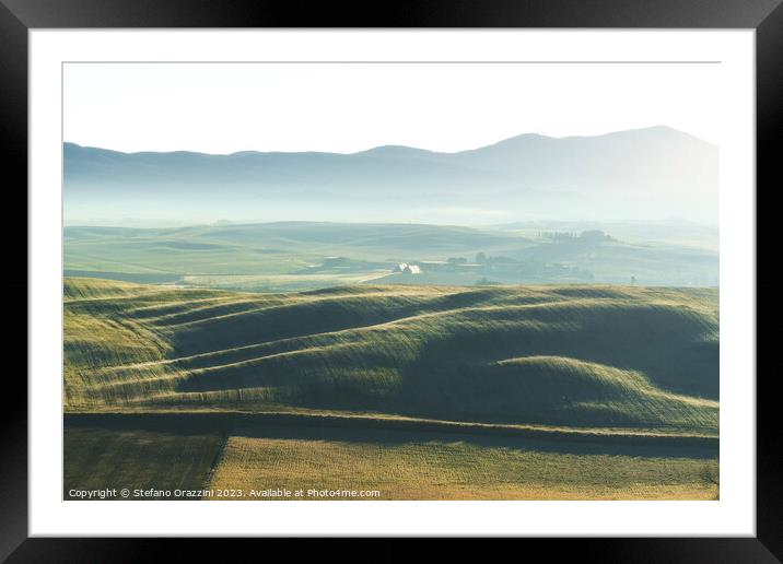 Foggy morning in Tuscany. Rolling hills at sunrise. Val d'Orcia Framed Mounted Print by Stefano Orazzini