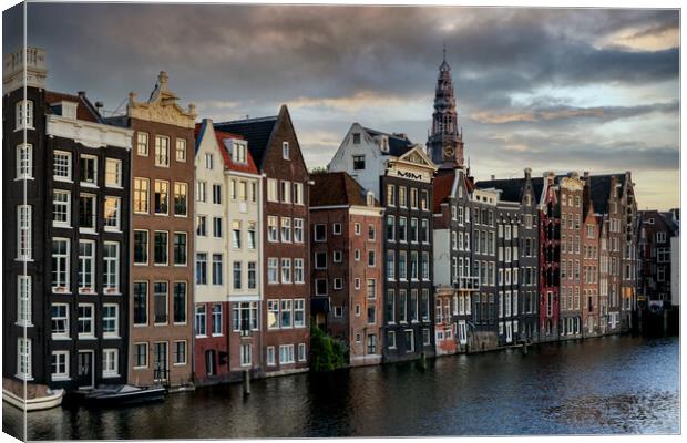 Houses along an Amsterdam canal. Summer cloudy day Canvas Print by Olga Peddi