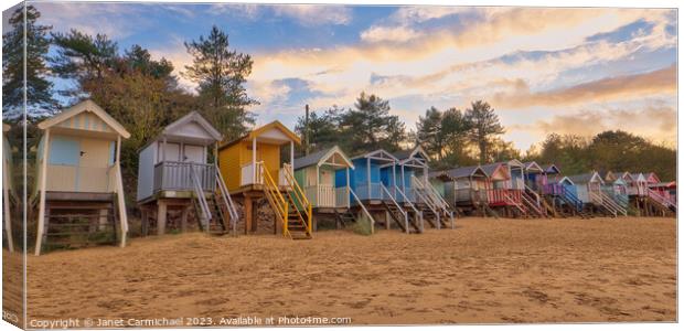 Rainbow Coloured Beach Huts at Wells Next the Sea Canvas Print by Janet Carmichael