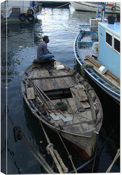 alone on boat Canvas Print by Hassan Najmy