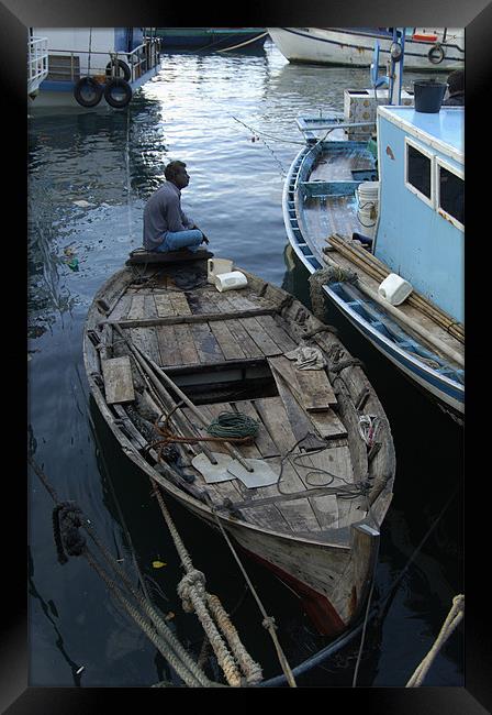 alone on boat Framed Print by Hassan Najmy