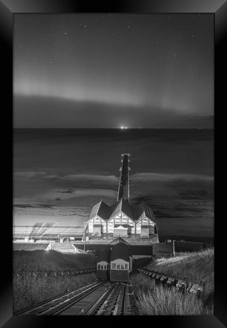 Aurora Borealis over Saltburn pier in Black and white Framed Print by Kevin Winter