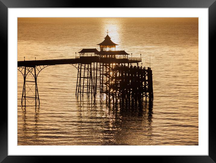 Clevedon Pier at sunset with a calm and tranquil sea Framed Mounted Print by Rory Hailes