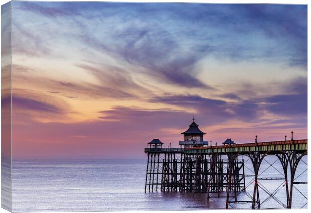 Clevedon Pier at sunset with a colourful sky and cirrus clouds catching the last of the sunlight Canvas Print by Rory Hailes