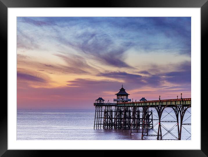 Clevedon Pier at sunset with a colourful sky and cirrus clouds catching the last of the sunlight Framed Mounted Print by Rory Hailes