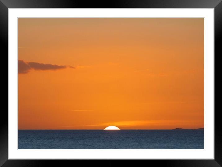 The sun setting over the horizon with an orangey in the sky Framed Mounted Print by Rory Hailes