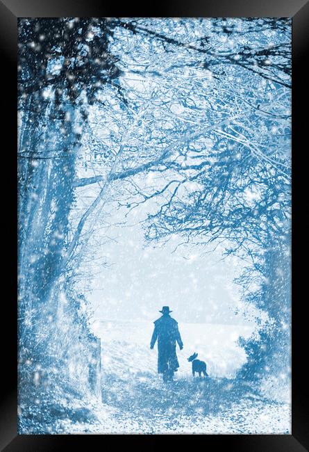 Shepherd and dog in the snow Framed Print by Maggie McCall