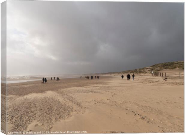 Winter Walkers at Camber Sands. Canvas Print by Mark Ward