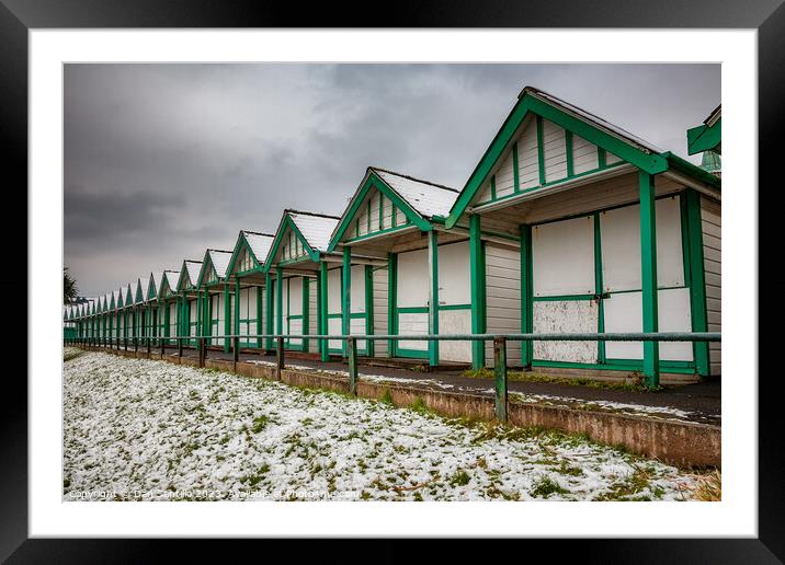Langland Bay Beach Huts in the snow Framed Mounted Print by Dan Santillo