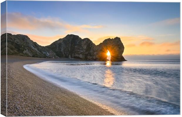 Sunrise through the arch of Durdle Door Dorset  Canvas Print by Shaun Jacobs