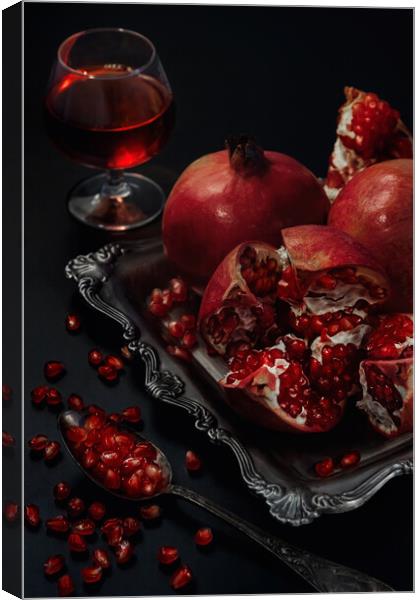Still life of pomegranates on a black background Canvas Print by Olga Peddi