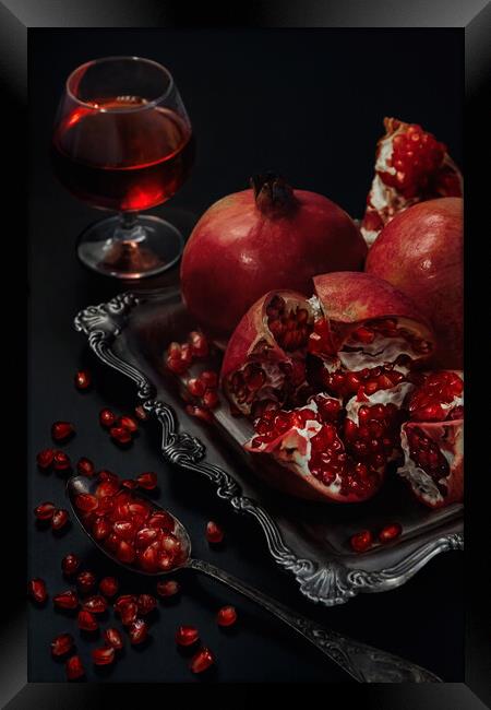 Still life of pomegranates on a black background Framed Print by Olga Peddi