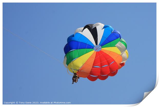 Parachute on a clear blue sky Print by Tony Davis