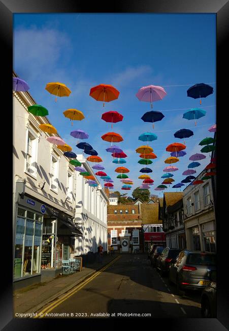 Bank Street with  umbrellas Hythe Kent  Framed Print by Antoinette B