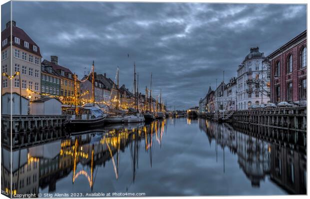 Christmas decorations in Nyhavn are reflected in the water durin Canvas Print by Stig Alenäs