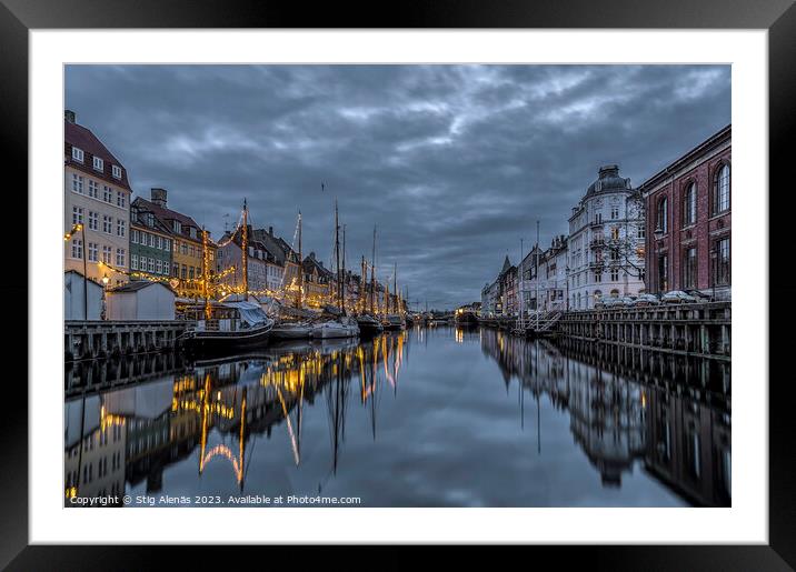 Christmas decorations in Nyhavn are reflected in the water durin Framed Mounted Print by Stig Alenäs