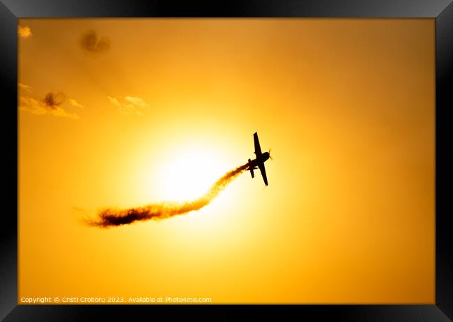Airplane flying at sunset.  Framed Print by Cristi Croitoru