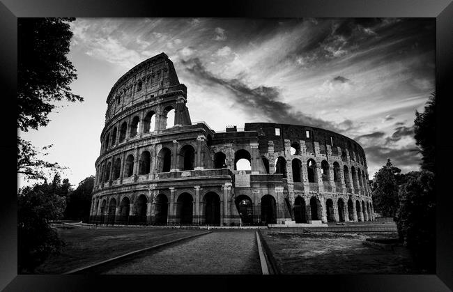 The fascinating sunset silhouette of the Colosseum in black and white. Framed Print by Guido Parmiggiani