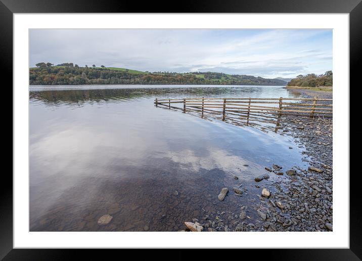 Fence dips into Lake Bala Framed Mounted Print by Jason Wells