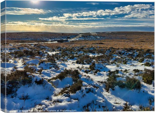 Dartmoor. Lonely road and snowy moorland. Canvas Print by Roger Mechan