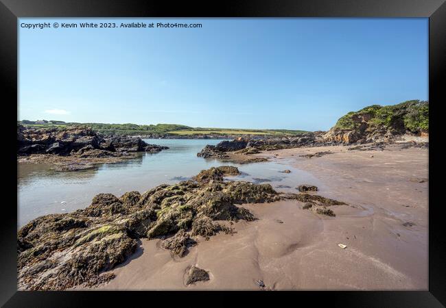 Sandy beach and rocks on Welsh coast Framed Print by Kevin White