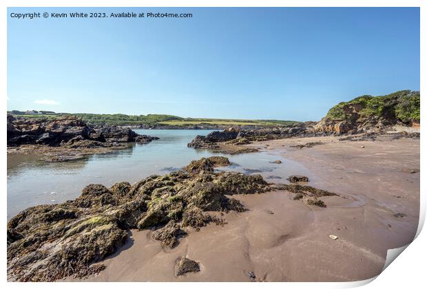 Sandy beach and rocks on Welsh coast Print by Kevin White