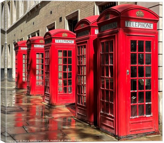 A chorus of red telephone boxes, London Canvas Print by Fiona Smallcorn
