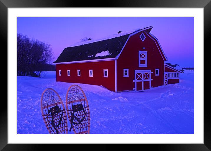 Snowshoes in Front of red barn Framed Mounted Print by Dave Reede