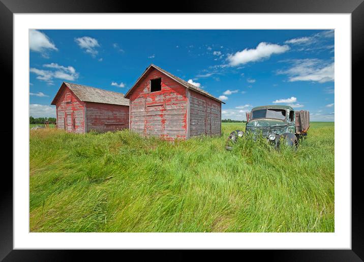 old farm truck beside grain bins Framed Mounted Print by Dave Reede