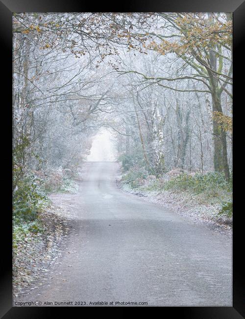 Frosty woodland road Framed Print by Alan Dunnett