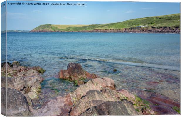 Interesting different coloured rocks on Manorbier beach Canvas Print by Kevin White