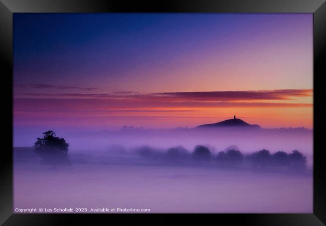 Glastonbury Tor in morning mist Framed Print by Les Schofield