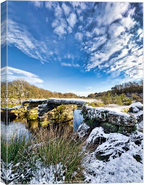 Dartmoor clapper bridge in the snow Canvas Print by Roger Mechan