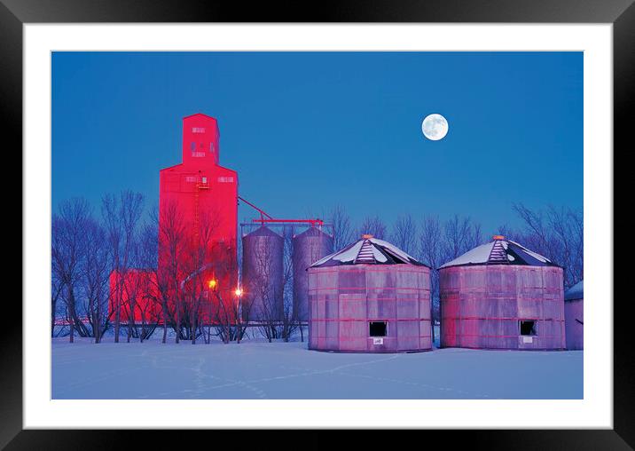 old grain bins on a farm next to a grain elevator Framed Mounted Print by Dave Reede