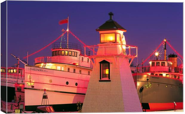 Christmas lights on ships and lighhouse Canvas Print by Dave Reede
