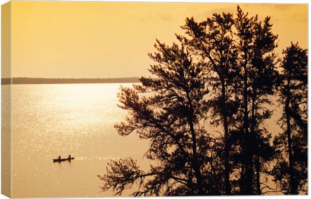 canoeing across Big Whiteshell Lake Canvas Print by Dave Reede