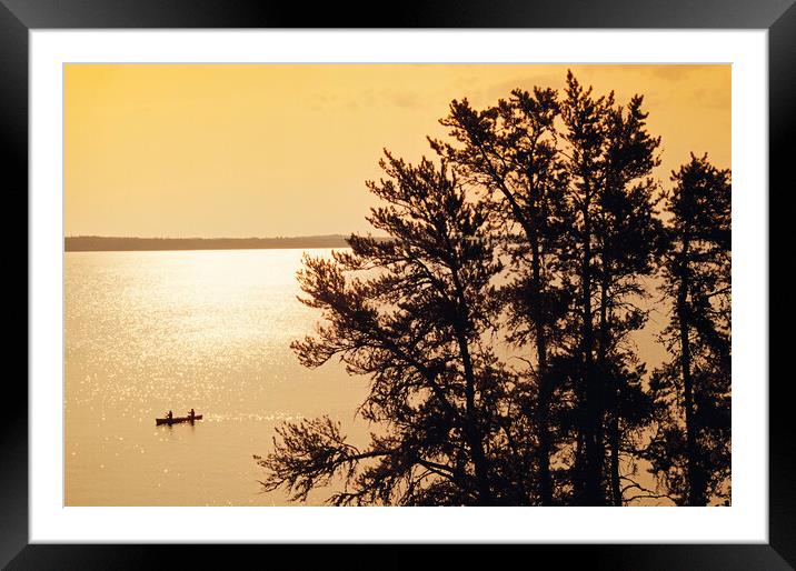 canoeing across Big Whiteshell Lake Framed Mounted Print by Dave Reede