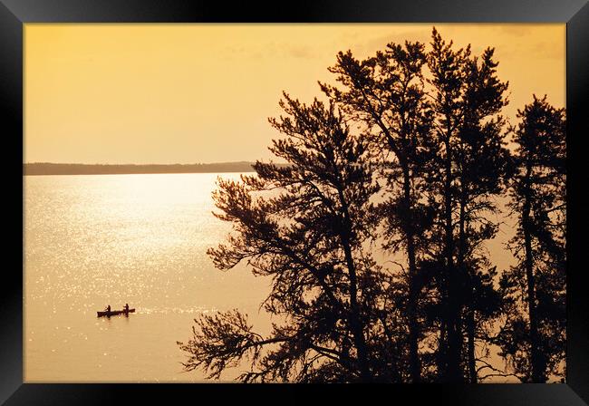 canoeing across Big Whiteshell Lake Framed Print by Dave Reede