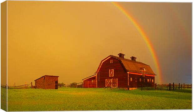old barn and rainbow in the background Canvas Print by Dave Reede