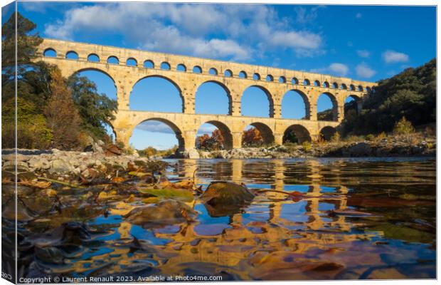 The Pont du Gard viewed from the river. Ancient Roman aqueduct b Canvas Print by Laurent Renault