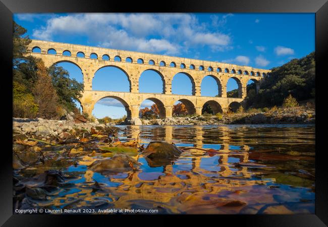 The Pont du Gard viewed from the river. Ancient Roman aqueduct b Framed Print by Laurent Renault