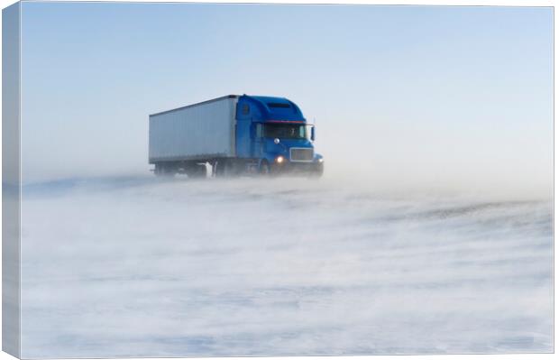 truck on road covered with blowing snow Canvas Print by Dave Reede