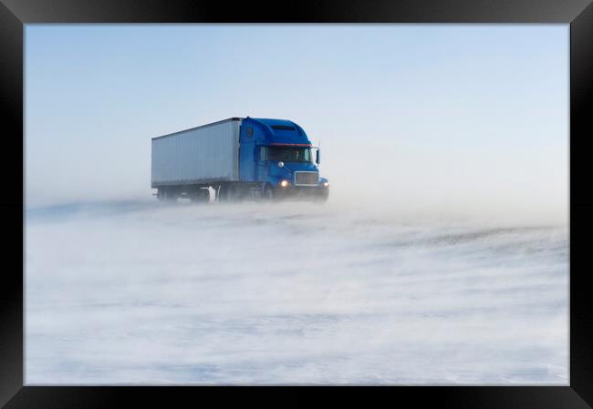 truck on road covered with blowing snow Framed Print by Dave Reede